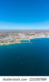 Vertical Photography Of Albufeira City. Perspective From Above. Situated In South Of Portugal Is A Famous Travel Destination. Beautiful Portuguese Landscape With High Rocky Shore And Luxury Houses.