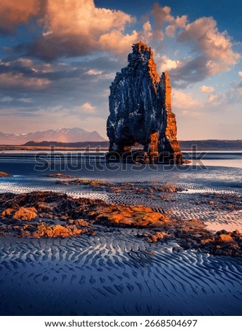 Vertical picture of huge basalt stack - Hvitserkur. Majestic morning scene of eastern shore of Vatnsnes peninsula. Dramatic summer sunrise in northwest Iceland. Beauty of nature concept background.