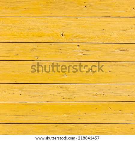 vertical picture of old horizontal planks with bright yellow paint