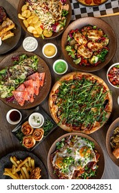 Vertical Pizza, Cinnamon Or Pepperoni Puff Pastry Rolls With Filling, Seafood Salad. Chick, Meat With Sauce, Fried Sliced Potato, Grill Salads, Scrambled Eggs With Spice, Carnitas. Flat Lay, Top View