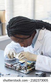 Vertical Portrait Of Black Female Engineer Working With Electronic Parts In Laboratory