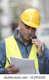 Vertical Portrait Of Engineer Smoking Electronic Cigarette. Outdoors