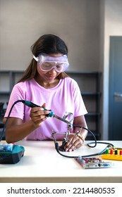 Vertical Portrait Of Female Teen Black High School Student In Class Learning Electronics. Copy Space. Girls In Science.