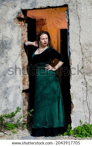 Similar – Melancholic girl with red dress in nature