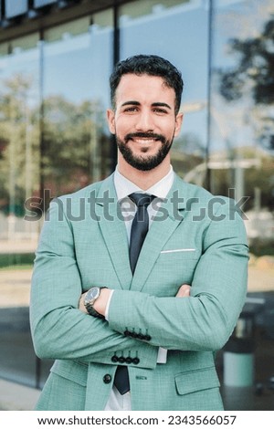 Vertical portrait of a handsome crossed arms business man executive looking at camera. Ambitious businessperson proud of job. Lawyer with suit at workspace. Corporate professional manager at office