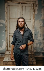Vertical portrait of man with dreadlocks, studio shot