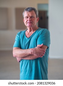 Vertical Portrait Of A Mature Man, Yoga And Pilates Instructor. He Looking Confident To The Camera.