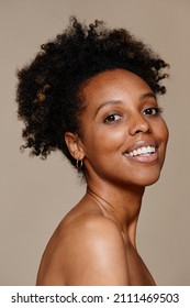 Vertical Portrait Of Young African-American Woman Demonstrating Beautiful Natural Skin And White Teeth Smile