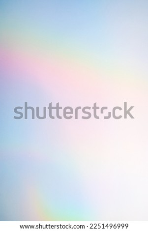 Vertical rainbow hologram background with iridescent colors.