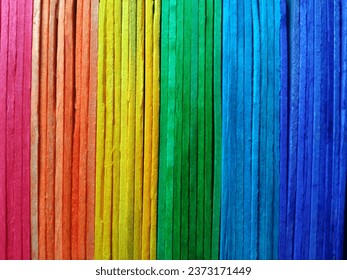 vertical rainbow pattern plank wall background texture for design or stock photo, colourful wooden, pink orange yellow green blue colors 
