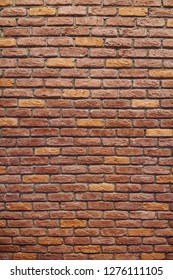 Vertical Red brick wall texture grunge background with vignetted corners.