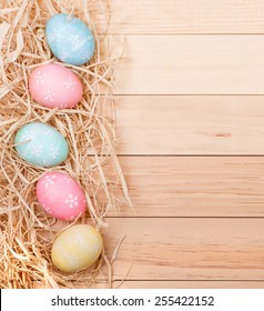 Vertical Row Of Easter Eggs On A Wood Background With Copy Space