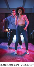 Vertical Screen: Diverse Multiethnic Couple In Cozy Clothes Recording A Dance Video From An Evening Party At Home In Loft Apartment. Performing For Funny Viral And Active Video For Social Media App.