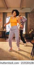 Vertical Screen: Happy Stylish Multiethnic Couple In Casual Outfits Recording A Dance Video From A Party At Home In Loft Apartment. Performing For Funny Viral And Active Video For Social Media App.