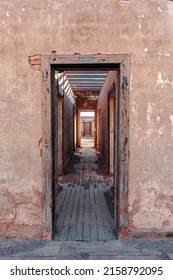 A Vertical Shot Of An Abandoned Broken House Door Frame