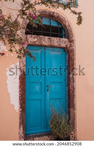 A vertical shot of an aged building entrance in Santorini, Greece