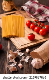 A Vertical Shot Of All The Ingredients Laid Out Needed For Making Pasta With Tomato Sauce