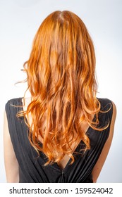 Vertical Shot Of Back View Of Red Curly Long Hair Of Beautiful Woman. Rear View Of Redhair Girl.