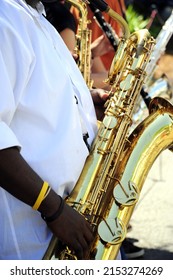 A Vertical Shot Of A Baritone Sax Player In Concert Outdoors