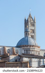 A Vertical Shot Of The Beautiful Medieval Siena Cathedral (Duomo Di Siena) On A Sunny Day In Italy