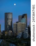 A vertical shot of the Bow and other skyscrapers and surrounding buildings in Calgary, Alberta, Canada