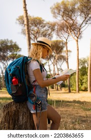 Vertical Shot Of Brave Woman Explores With Her Map In The Middle Of The Savannah