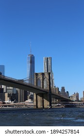 A Vertical Shot Of A Bridge Over The River In New York City, The USA