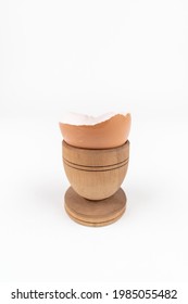 Vertical Shot Of Broken Egg Shell In Old Wooden Egg Stand. Minimalism. Conceptual Art For Food Or Animal Products. Sustainability Issue. Simple Breakfast.