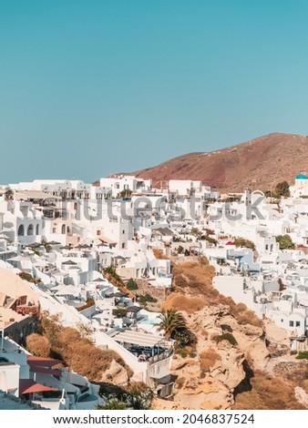 A vertical shot of buildings of Santorini - one of the Cyclades islands in Greece