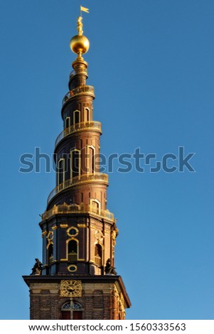 A vertical shot of the Church of Our Saviour under the blue sky captured in Copenhagen, Denmark