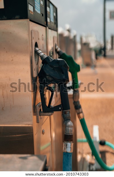 A\
vertical shot of diesel filling station on a sunny\
day