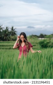 A Vertical Shot Of An East Asian Girl Enjoying Her Time In A Field 