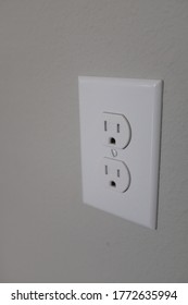 A Vertical Shot Of An Electric Plug -- Side View On The Wall