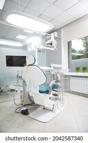 Vertical Shot Of Empty Dental Chair At Dentists Office