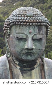 A vertical shot of the face of Kamakura Buddha in the Buddhist temple in Kamakura, Japan