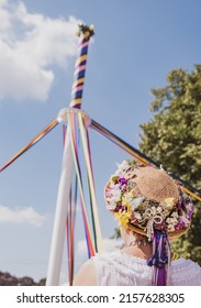 A vertical shot of a female in a traditional hat making a maypole at the English Countryfile Live