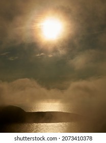 A vertical shot of a foggy sunset in Nordkapp, Norway