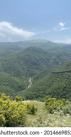 A Vertical Shot Of Forested High Peak Mountains At Daylight