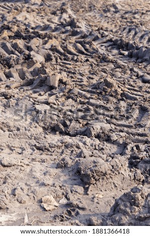 A vertical shot of ground and tracks texture left by vehicles