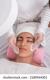 A Vertical Shot Of Hands Of Aesthetician Performing Facial Cleansing