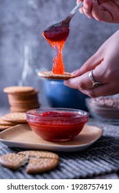 A Vertical Shot Of Hands Making Fresh Maria Cookie (galletas Maria) With Strawberry Jam