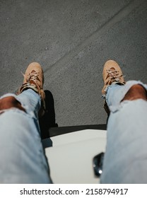 A Vertical Shot Of Legs Of A Guy Wearing Jeans And Stylish Shoes