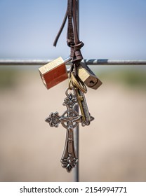 A vertical shot of locks and a cross in Marfa, Texas