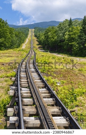 Vertical shot of a long straight part at the beginning of the Mt Washington cog railway track, New Hampshire, USA