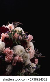 A vertical shot of a luxurious bouquet of pink roses and white, red dahlias on a black background - Shutterstock ID 1738924562