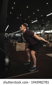 Vertical Shot Of A Male Athlete Working Out On Ski Erg Machine At The Gym