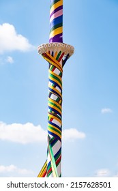 A vertical shot of a Maypole with colorful strings at Countryfile Live, Oxfordshire