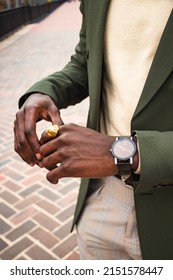 A Vertical Shot Of A Modern Watch On A Man's Hand In A Green Suit Jacket