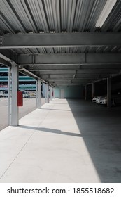 A Vertical Shot Of A Multistorey Car Park With Cars