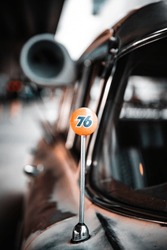 A Vertical Shot Of A Number Sign On A Classic Car